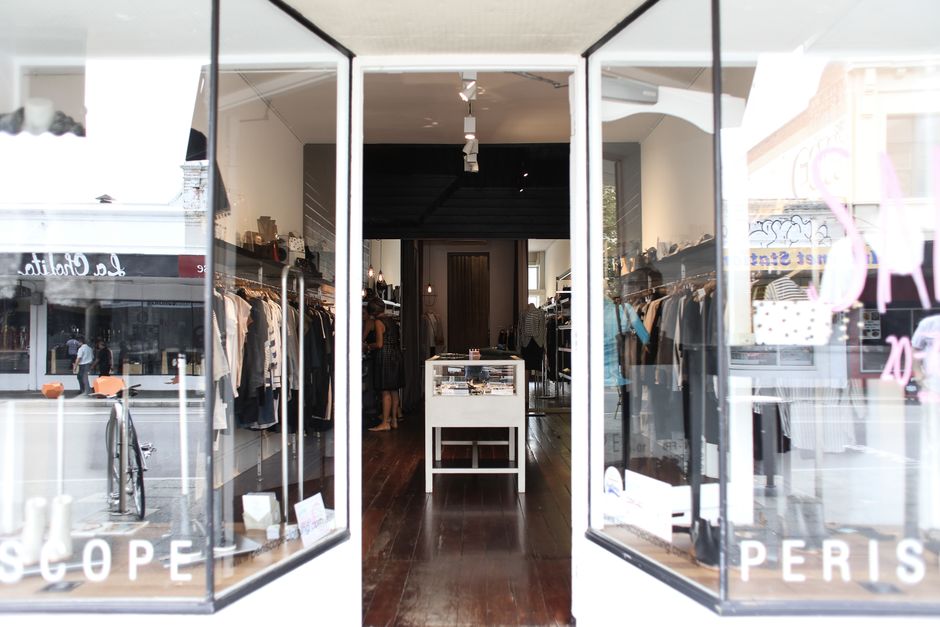 Elegant boutique showcasing clothing and accessories in a chic, modern setting.